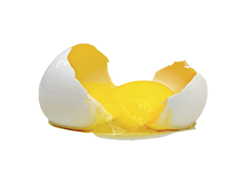 there is a broken egg on the table with a black background
