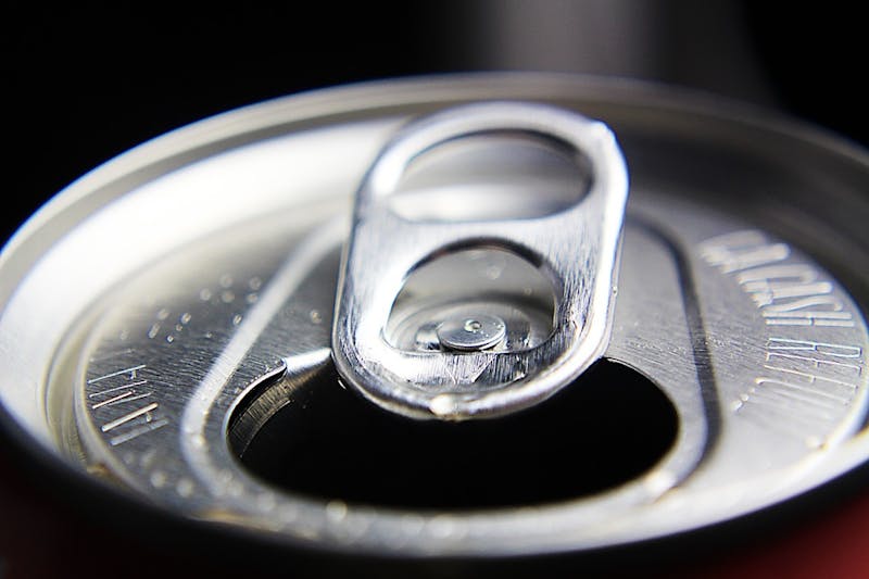 a close up of a can with a drop of water on top