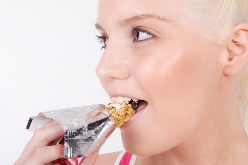blond woman eating a snack