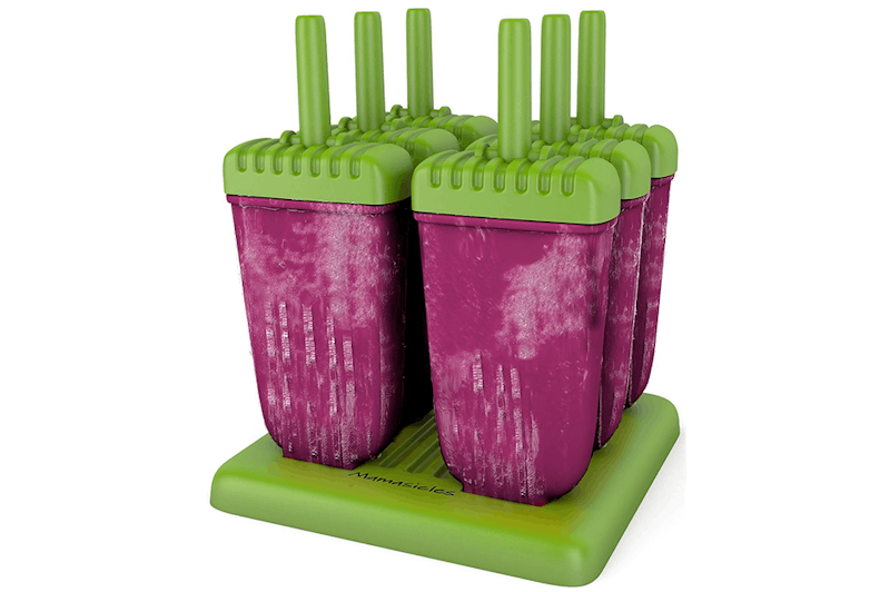 there are four popsicles on a green stand with pink and green tops