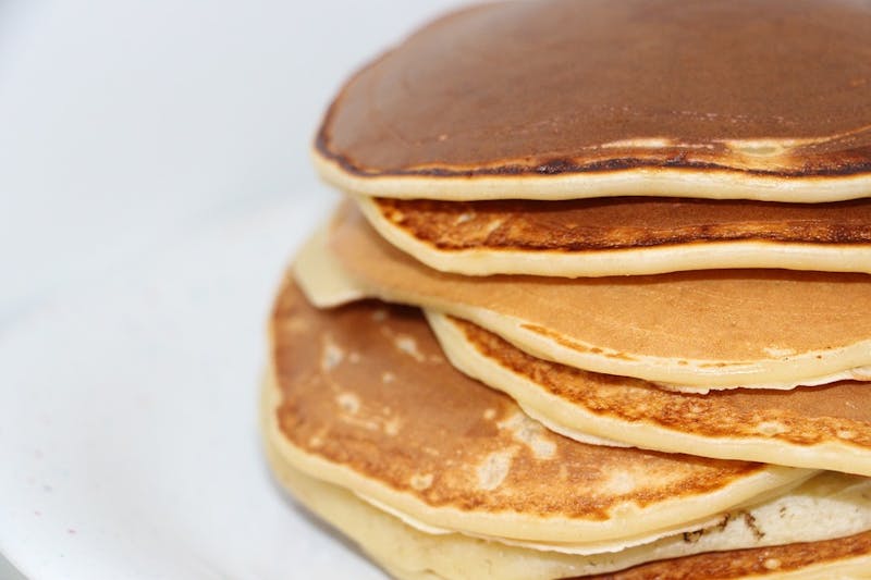 a close up of a stack of pancakes on a plate