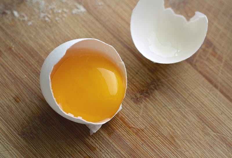 there is an egg that is broken in half on a table