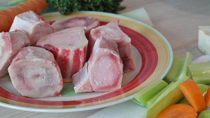 there are many pieces of meat on a plate with carrots and celery