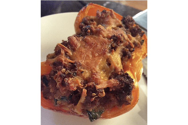 there is a plate with a stuffed pepper on it