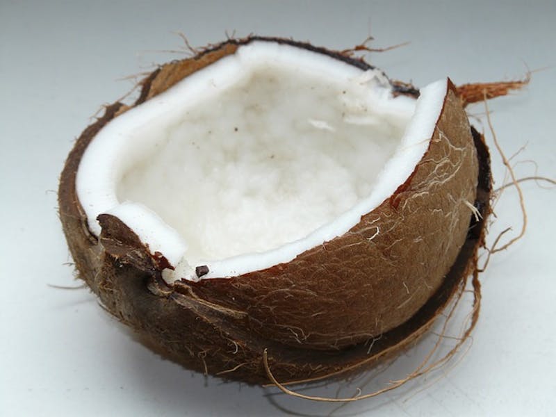 there is a half broken coconut on a white surface