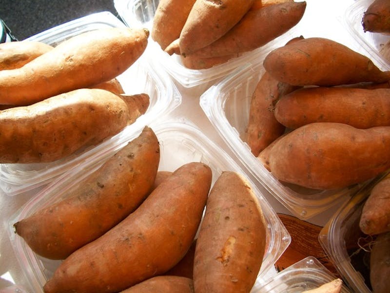 several containers of sweet potatoes are sitting on a table