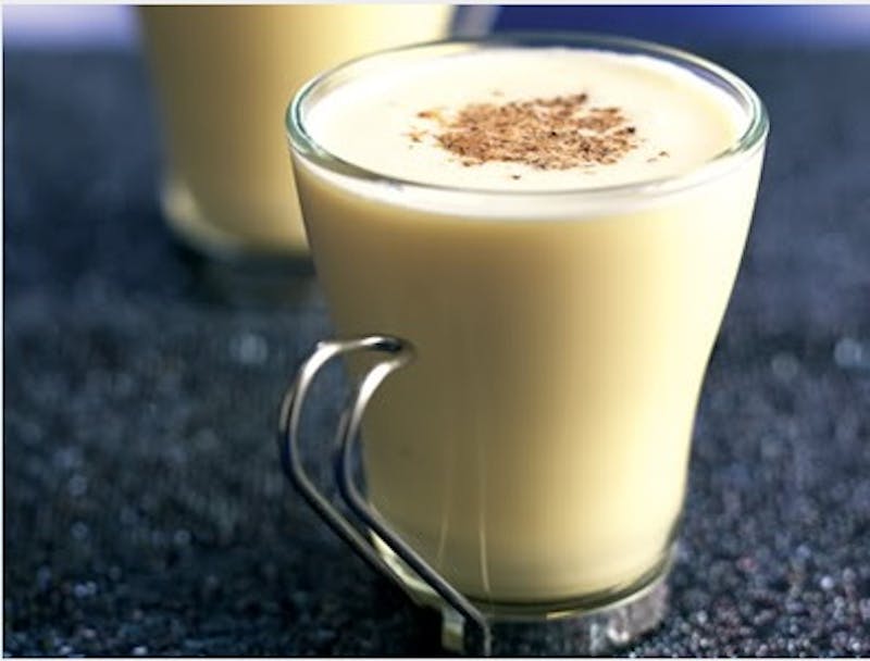 there are two glasses of egg nog with a cinnamon sprinkle on top