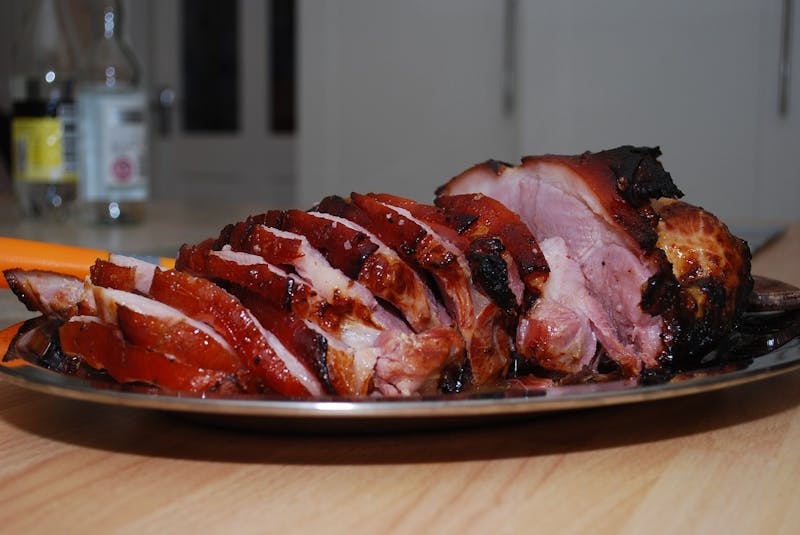 there is a plate of meat with a carrot on it
