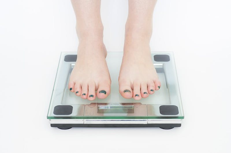 close up of someone's feet on a scale with a nail polish