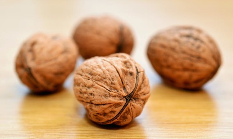 a close up of a group of walnuts on a table