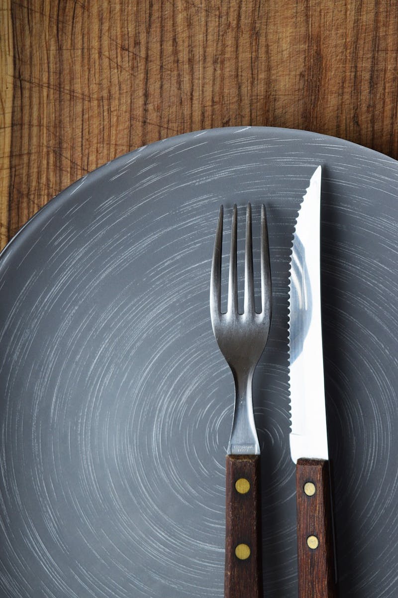 close up of a knife and fork on a plate