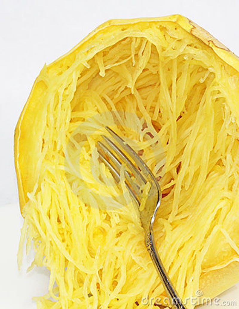 a close up of a fork inside spaghetti