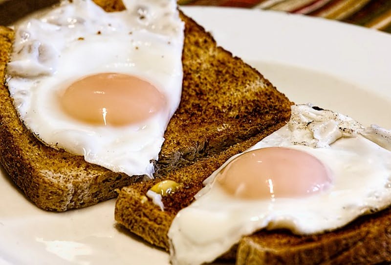 there are two eggs on toast on a plate with a fork