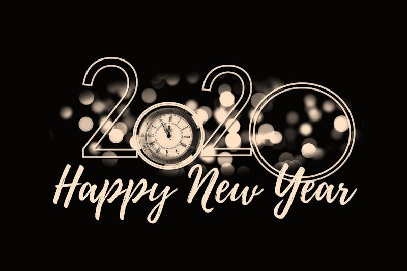 happy new year 2020 with a clock and bokeh lights