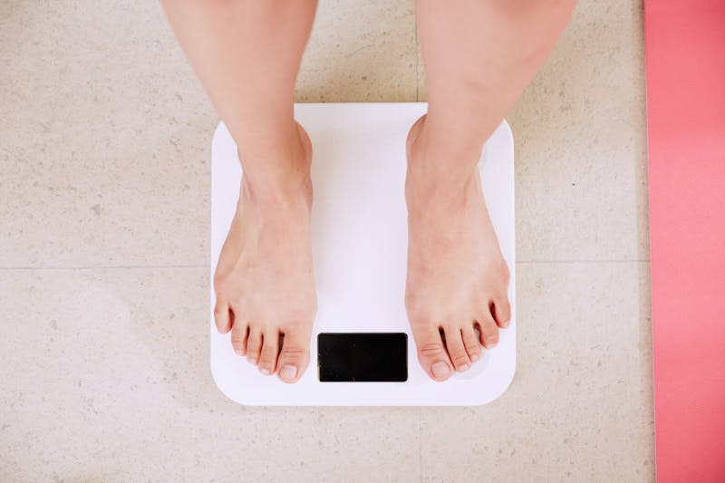 close up of a woman's feet standing on a scale