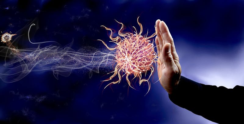 close up of a hand stopping an energy ball