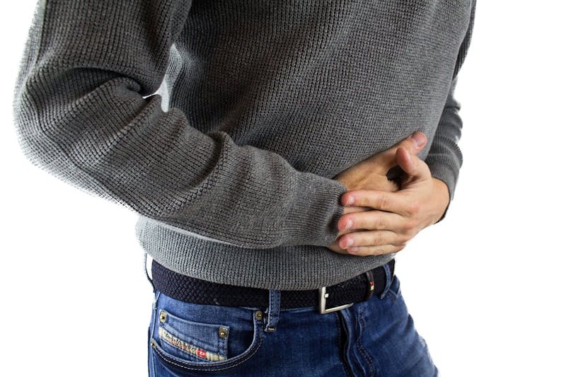 close up of a person with their hands on their stomach