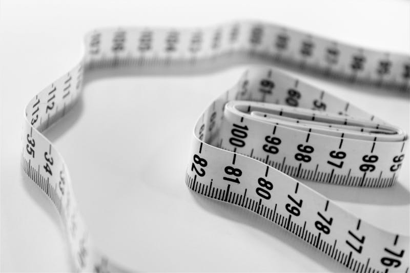 a close up of a measuring tape on a white surface