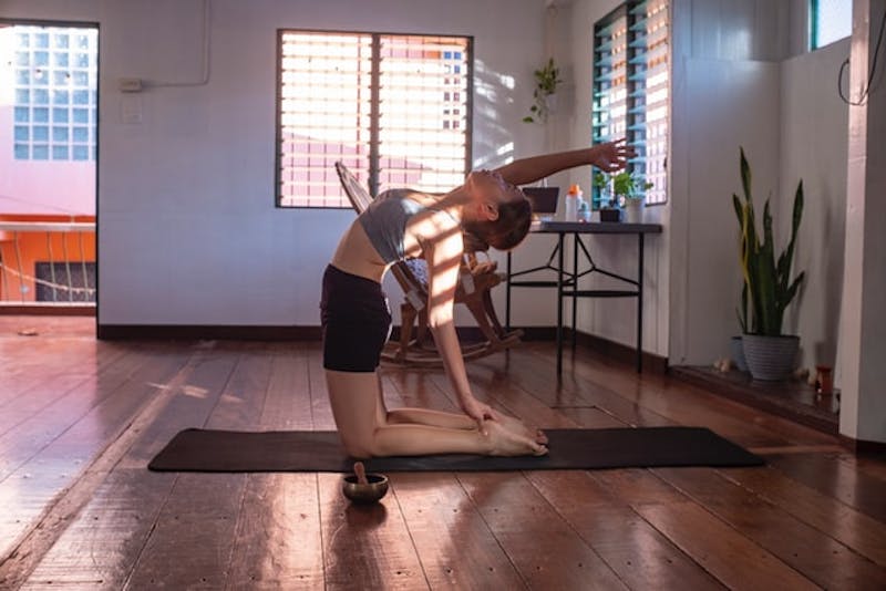 a woman doing a yoga pose on a mat