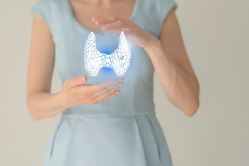 close up of a woman holding a glowing object in her hands