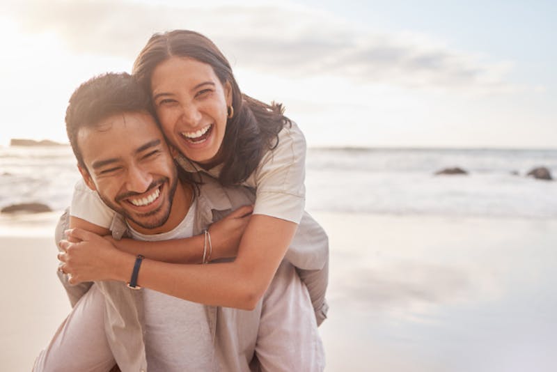a happy man and woman that are on the beach