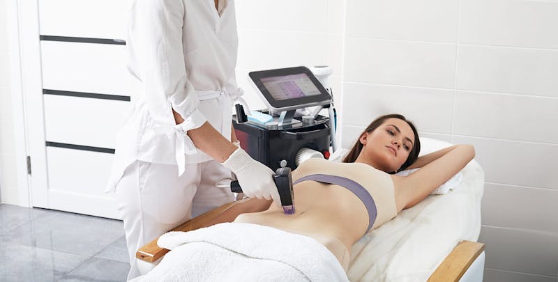 woman getting a laser treatment with a doctor