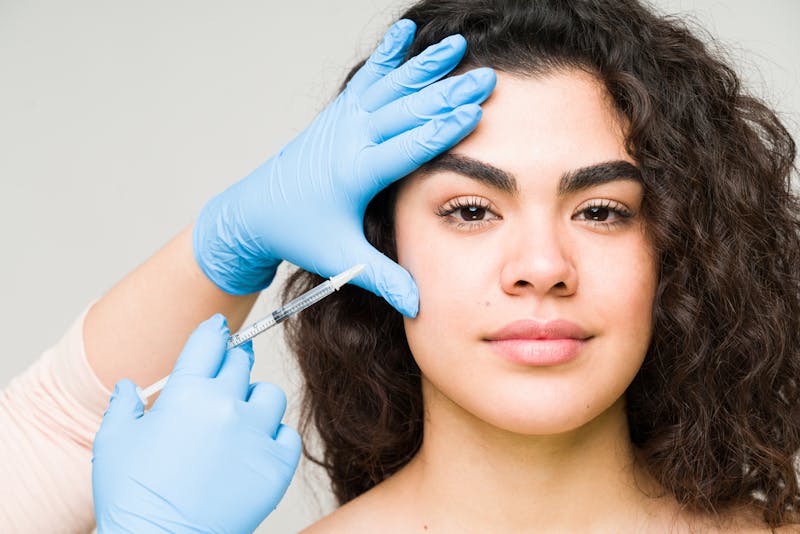 woman getting an injection done by a doctor