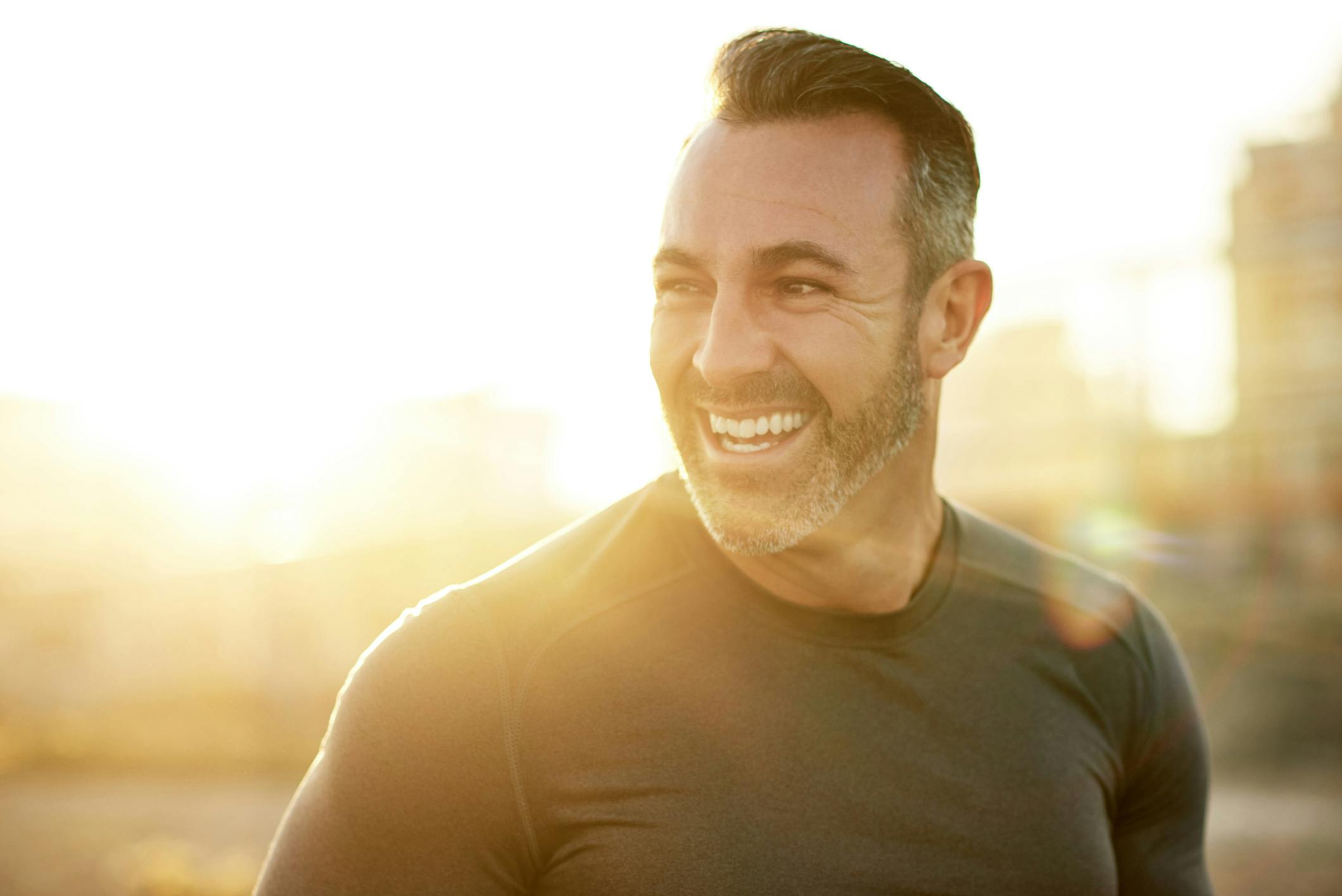 smiling man with lens flare