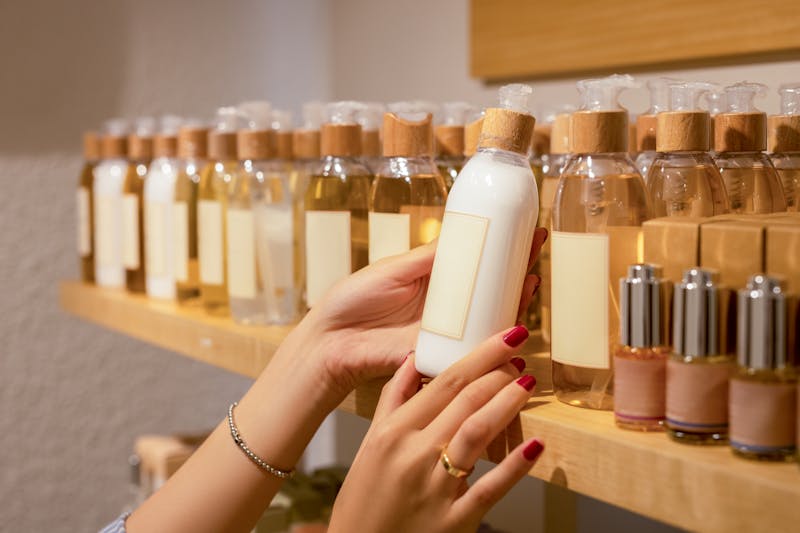 woman grabbing skin care product from shelf