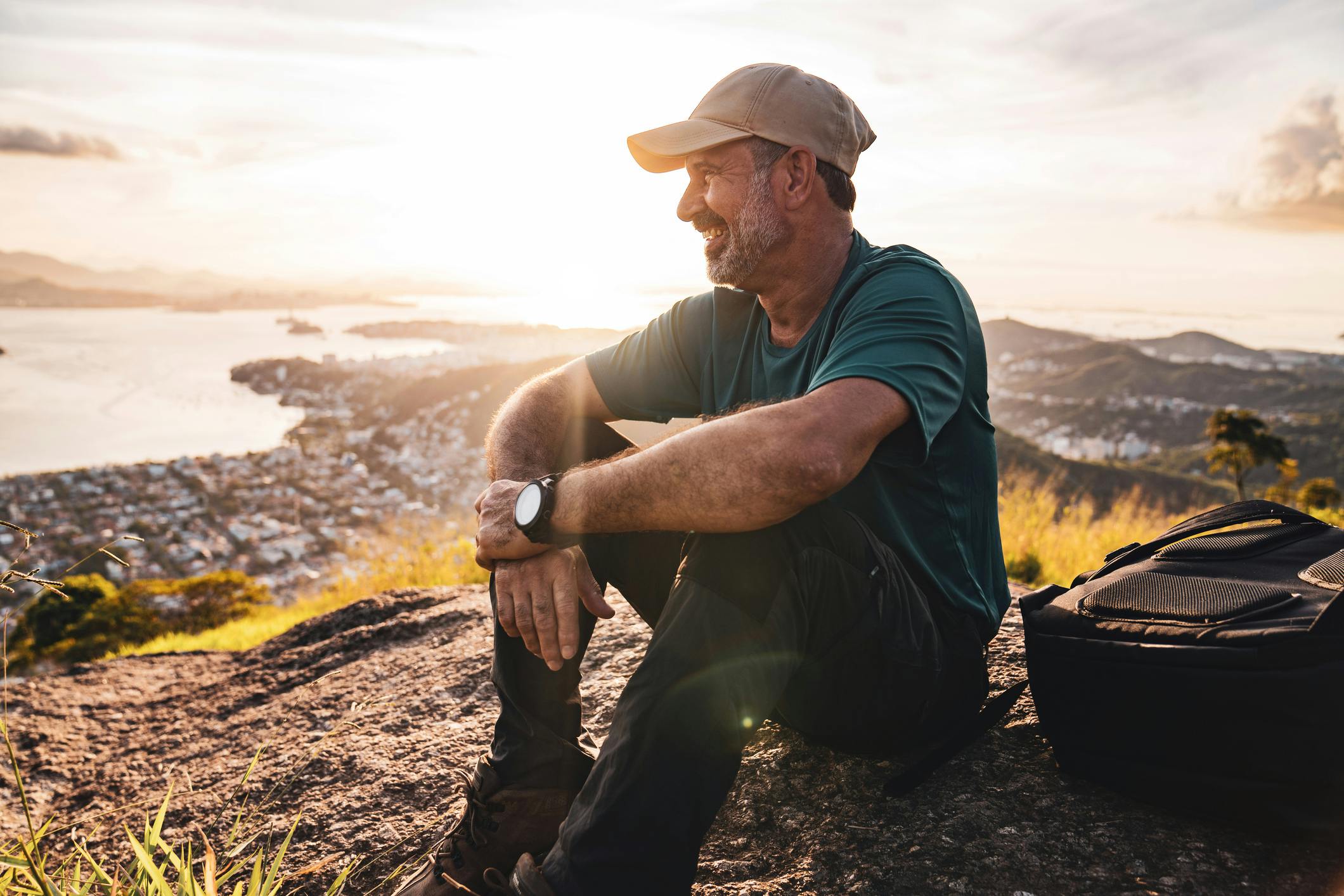 man on hill with backpack
