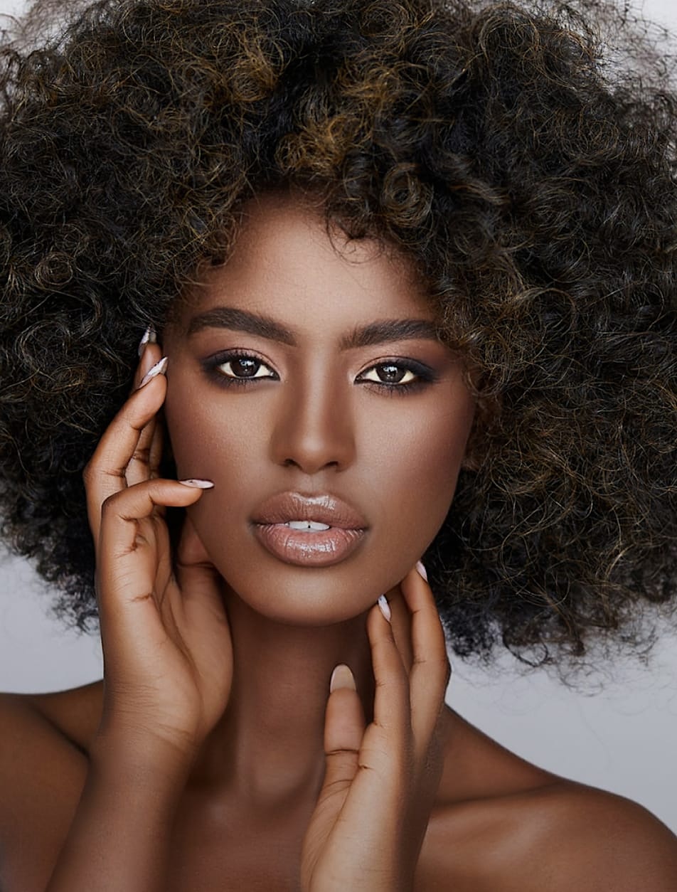 Beautiful woman holding her face