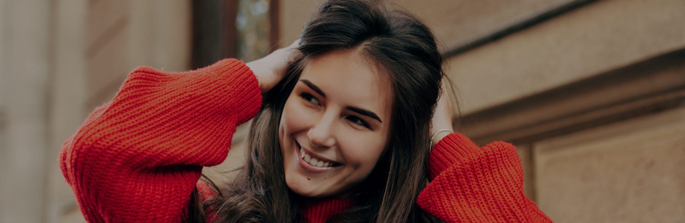 Woman in a red sweater smiling