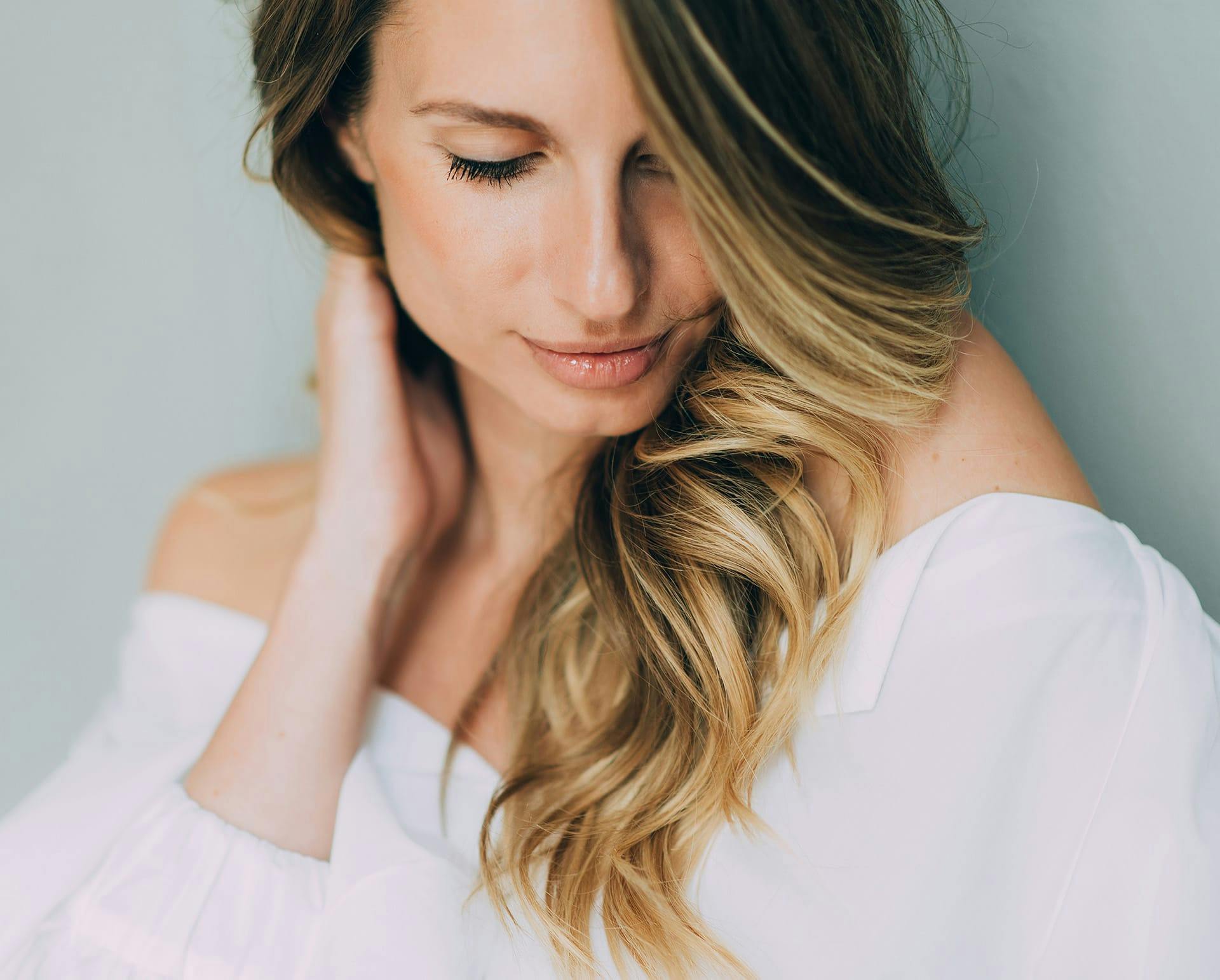 Blonde woman wearing a white top