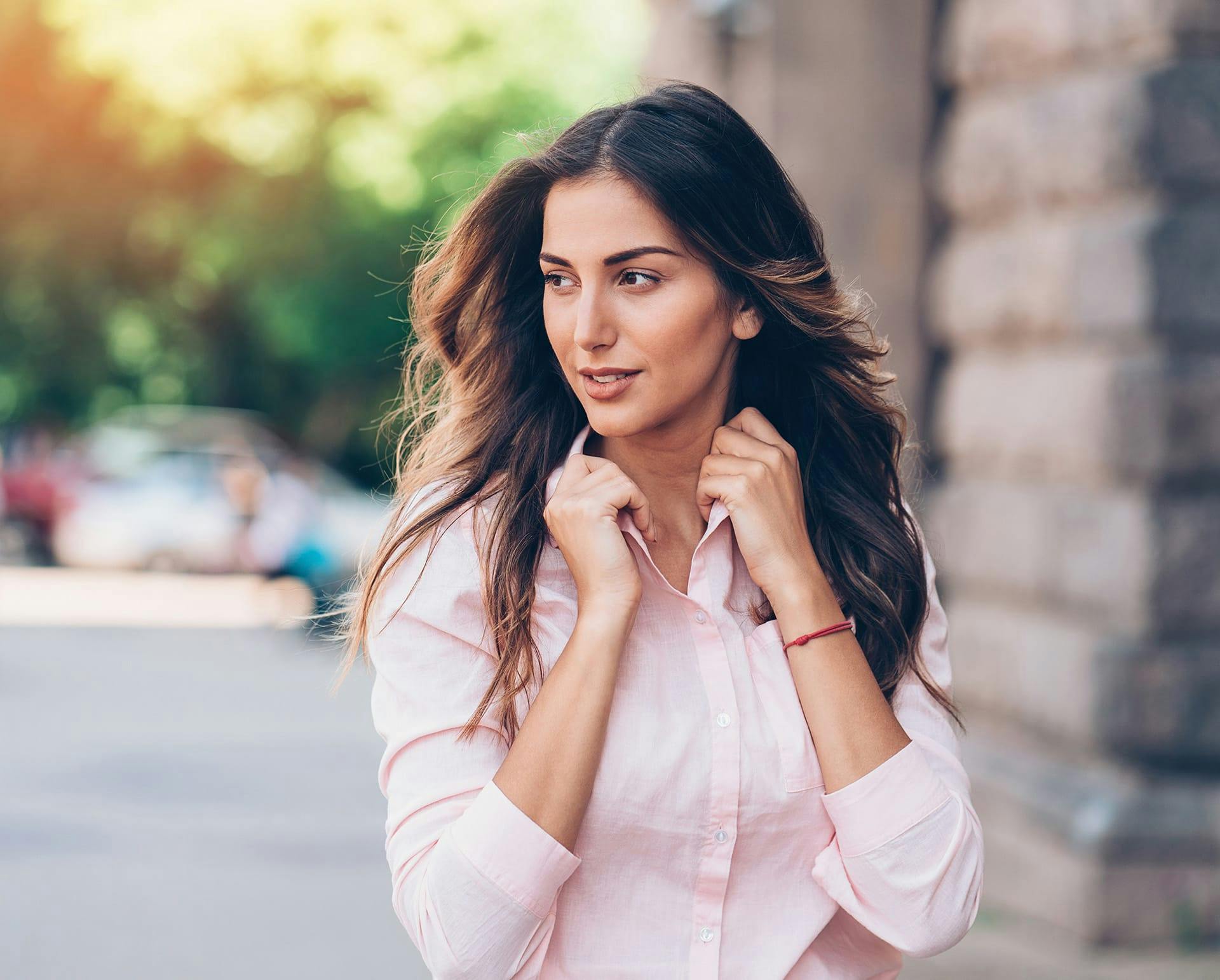 Woman wearing a pink button up