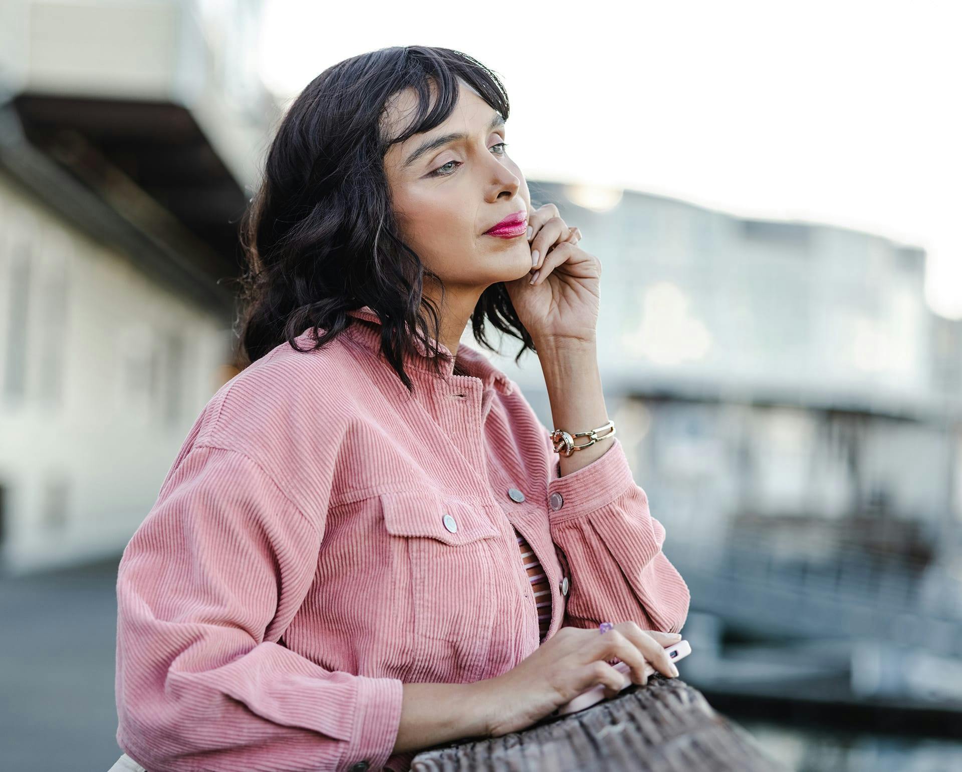 Woman in a pink jacket outside