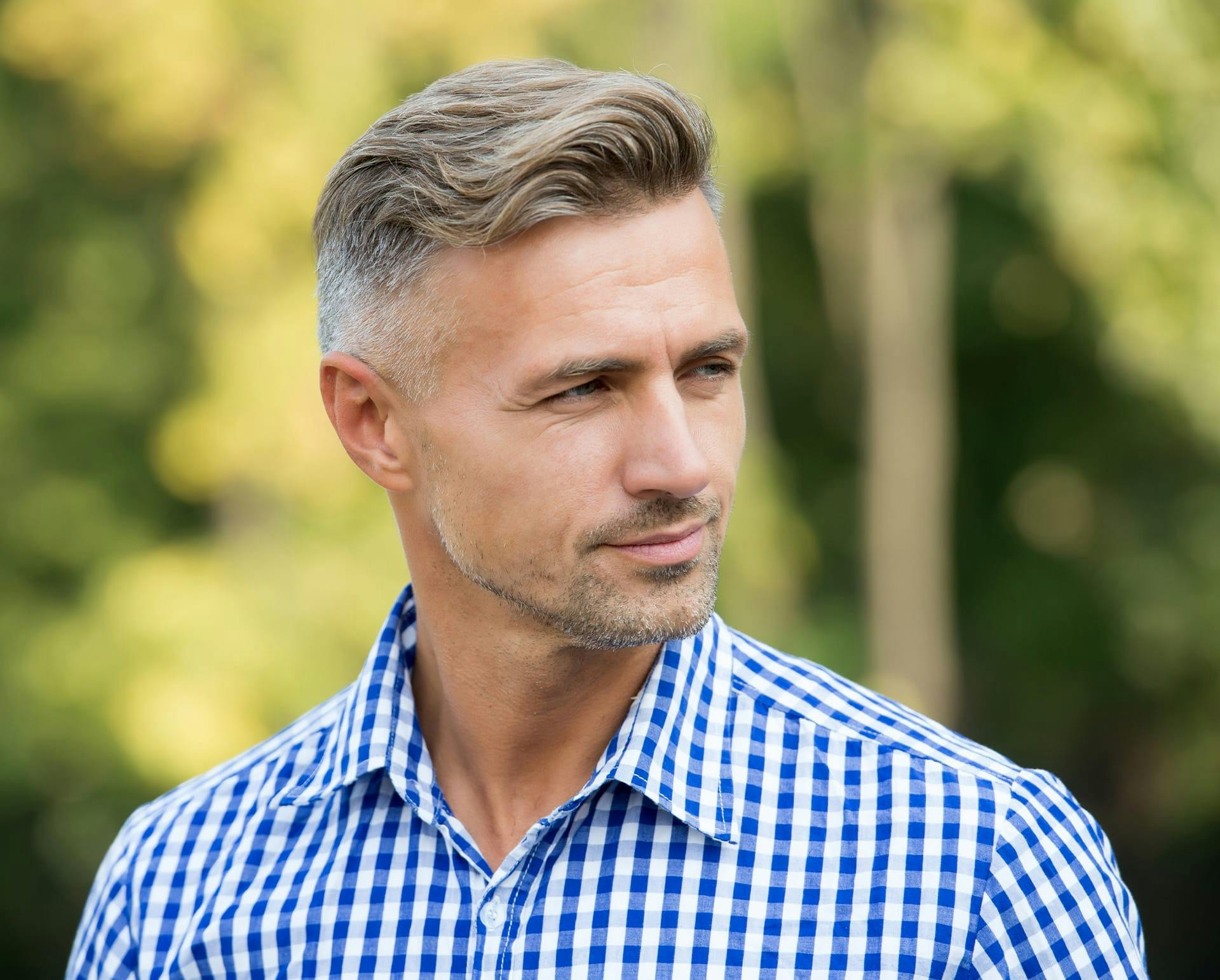 Man in blue and white button down outside