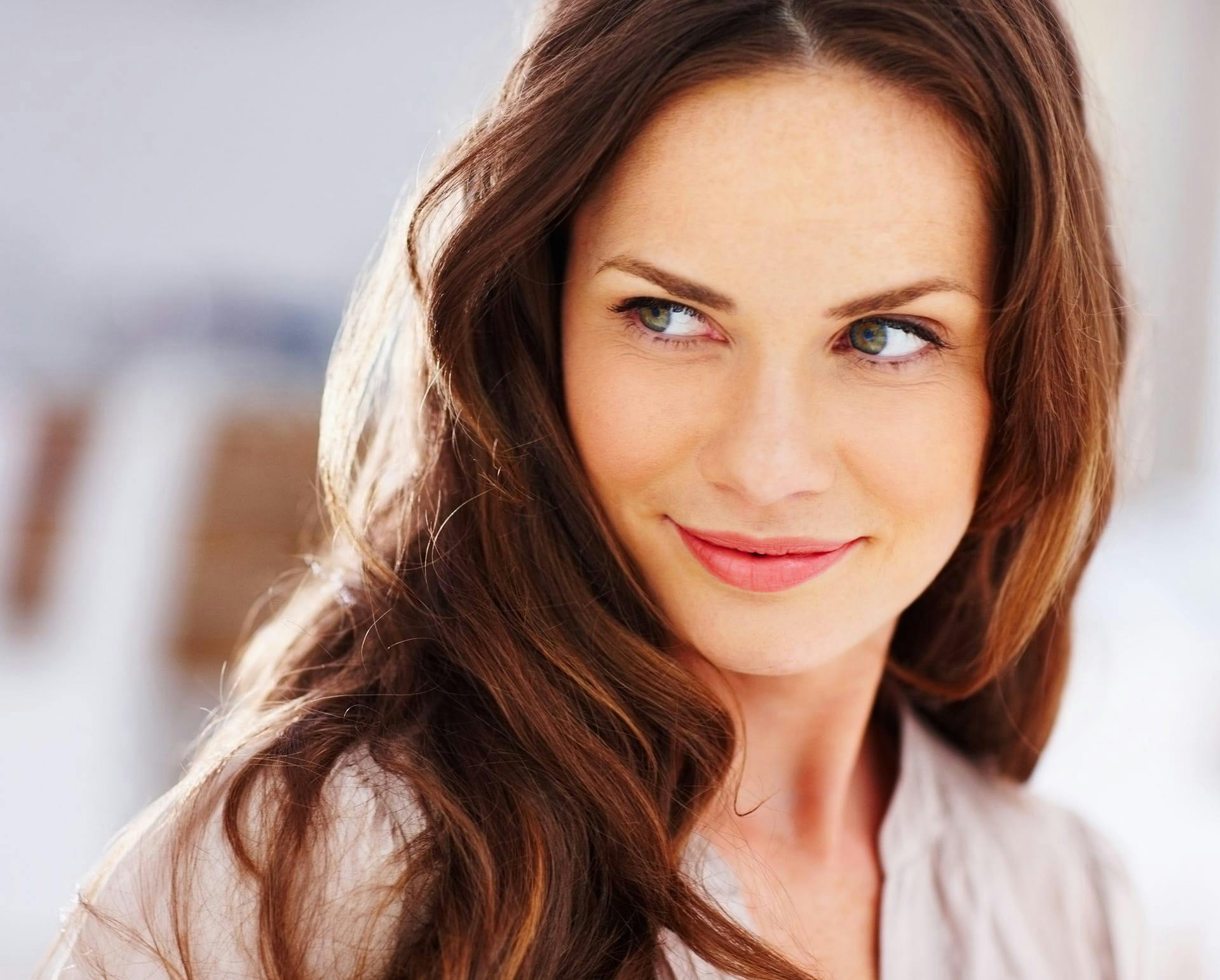 Woman with auburn hair looking to the side