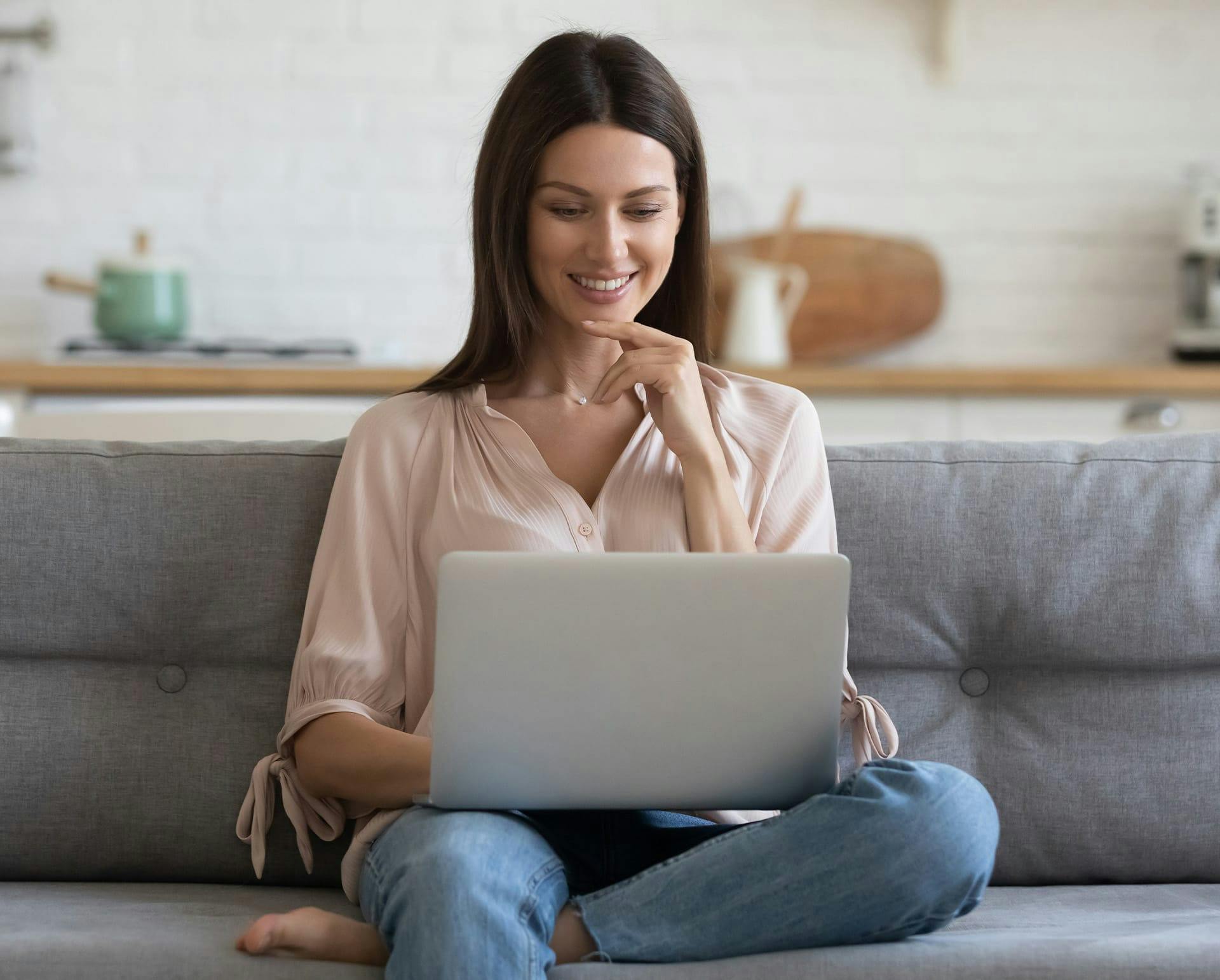 Woman sitting down on her laptop