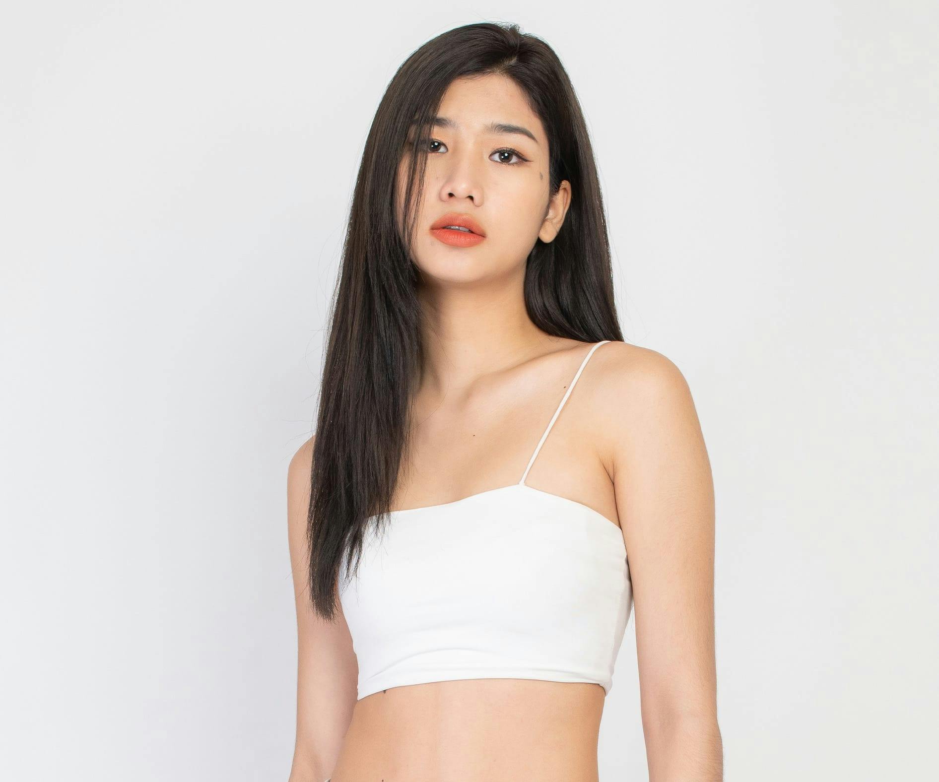 Woman with long black hair in white top