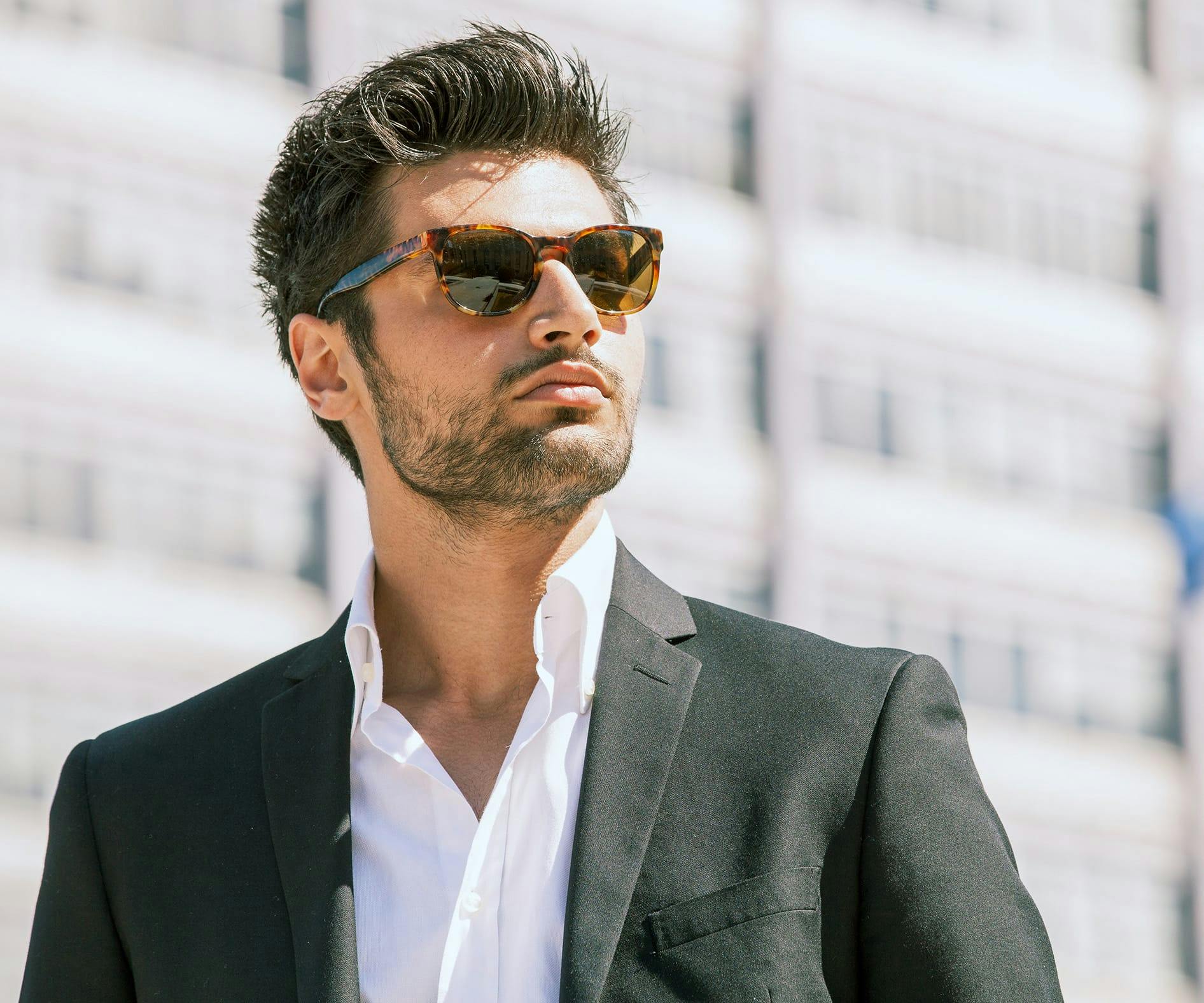 Man wearing a blazer and sunglasses outside