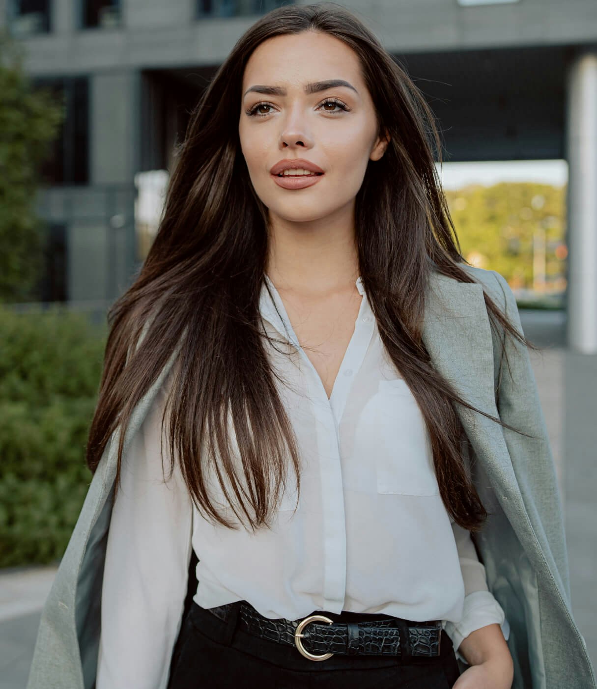 Confident woman walking outside
