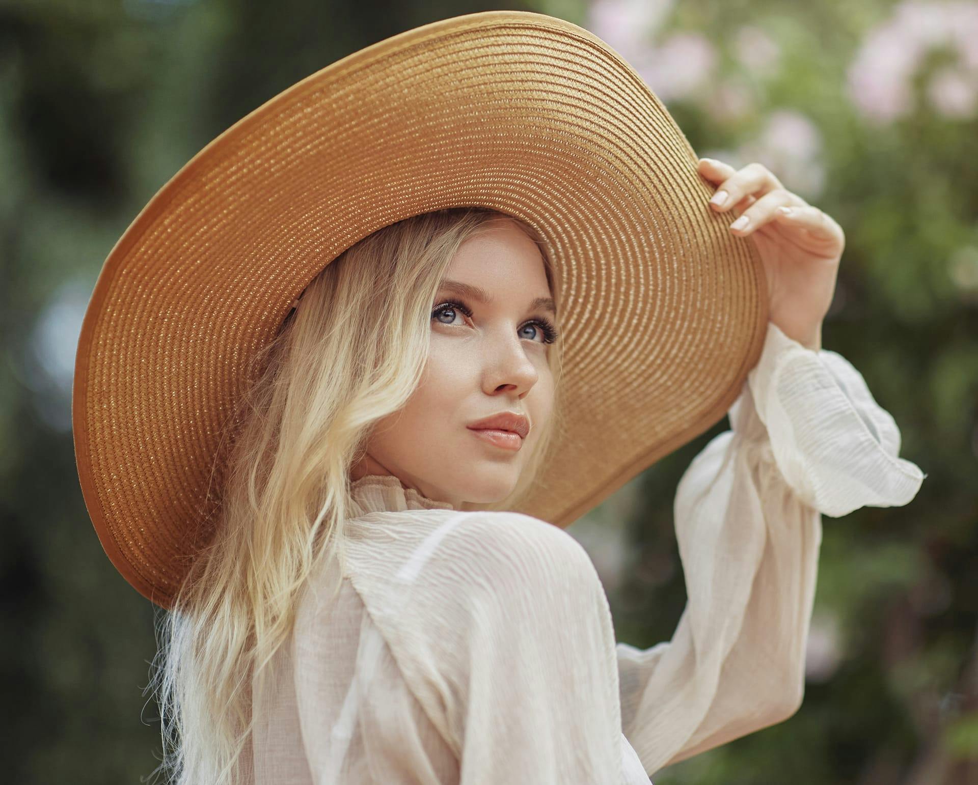 Woman in a straw hat outside