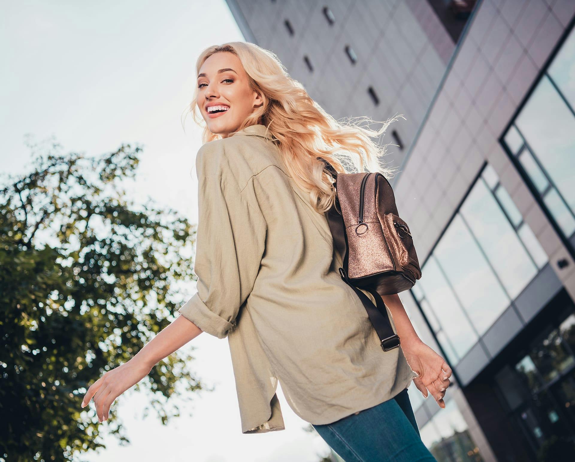 Woman outside wearing a sparkly backpack