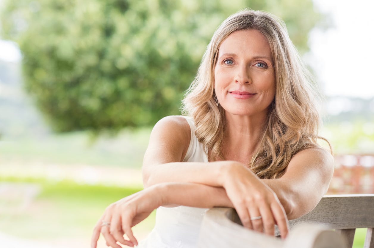 Woman sitting on a chair outside