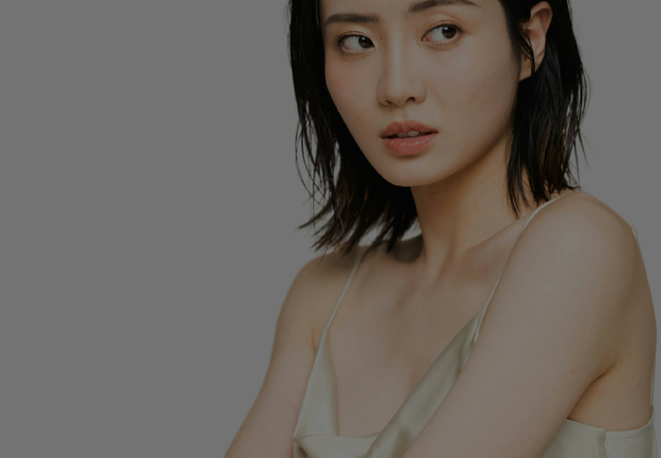 woman in a white dress posing for a picture