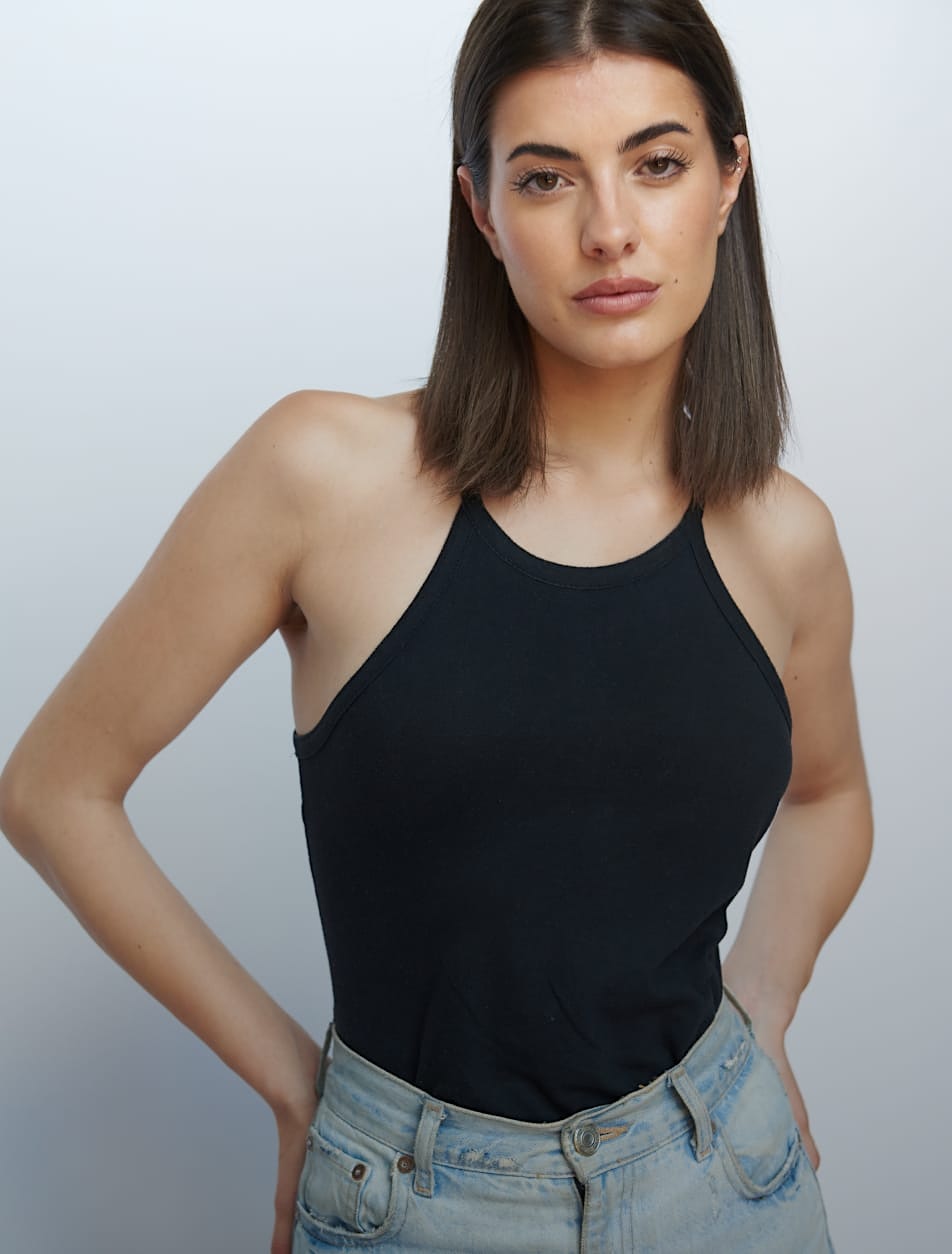 woman in a black top and jeans posing for a picture