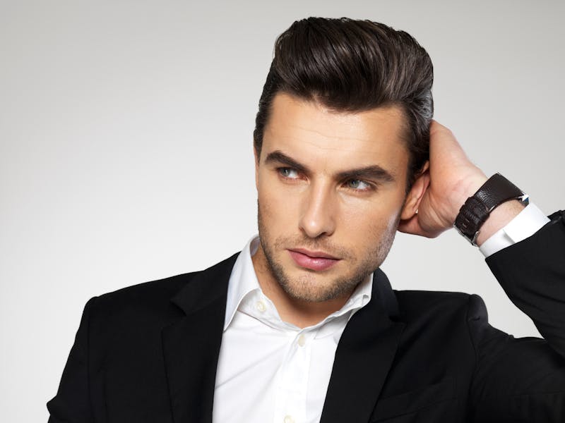 there is a man in a suit and a watch on his wrist