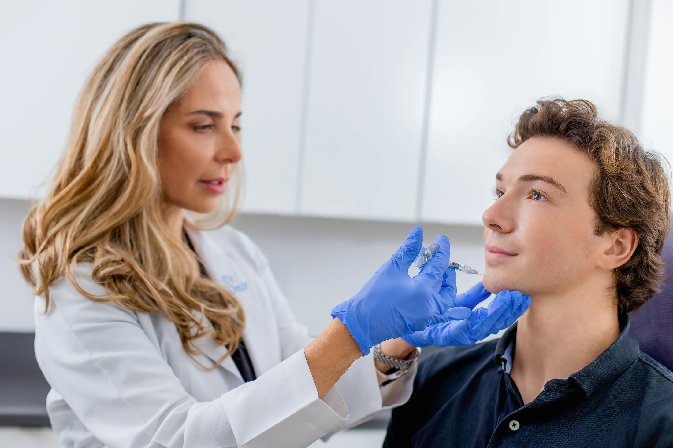 Dr. Onir giving filler injection to male patient