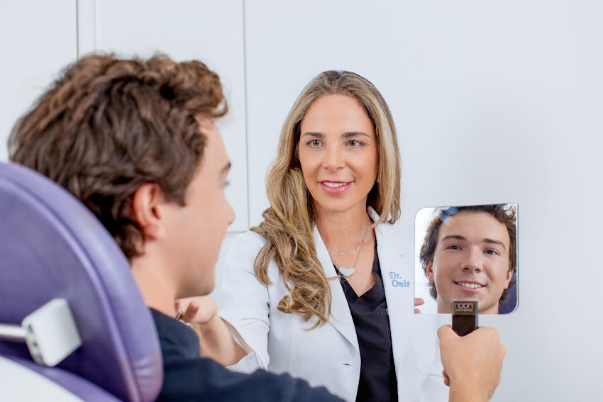 Dr. Onir with male patient looking in mirror