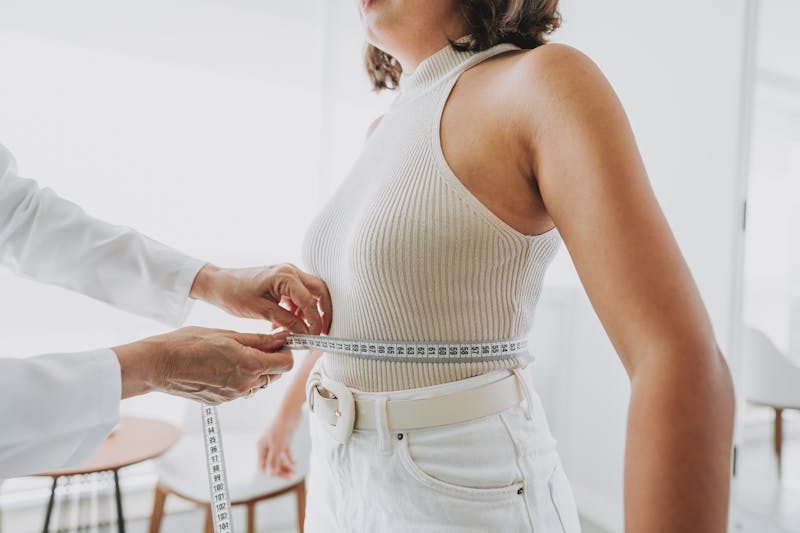 woman with measuring tape around waist